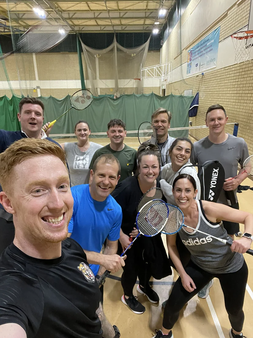 JungleFit members with badminton rackets at a sports hall social