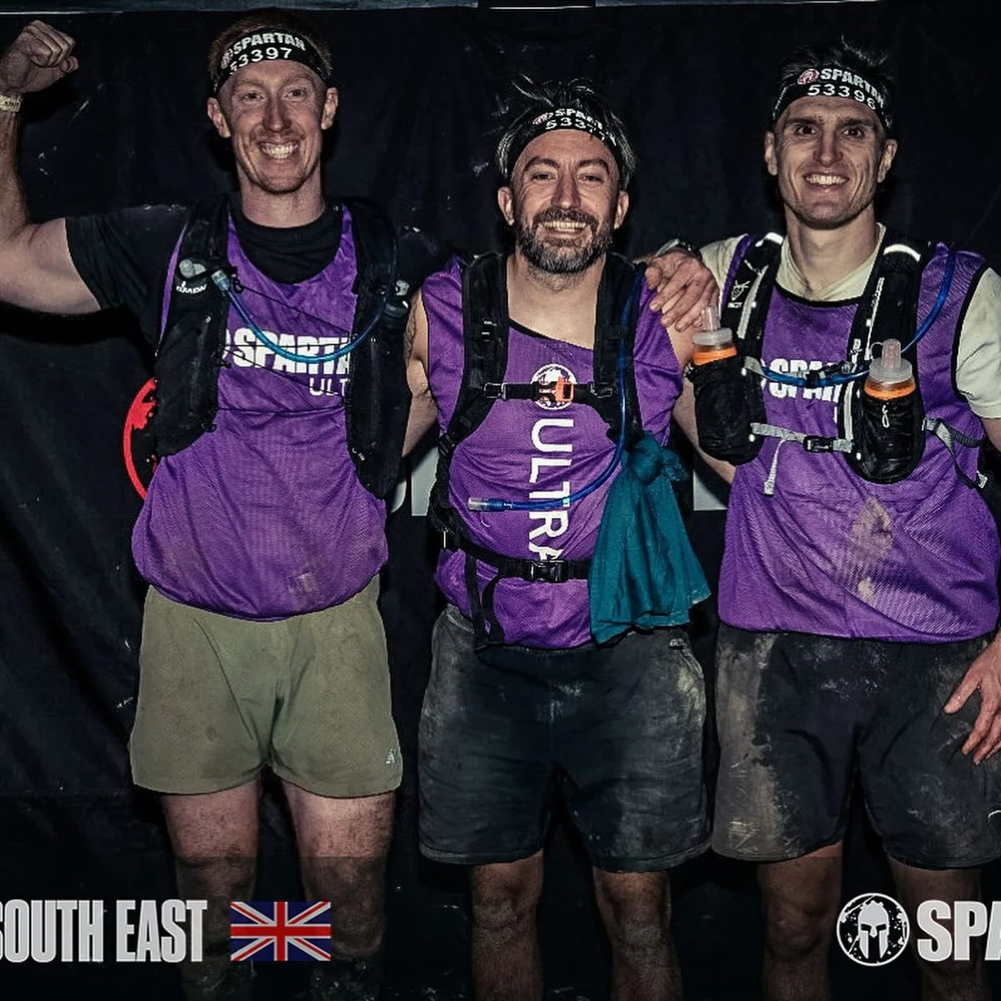 Three muddy JungleFit members at the finish of a Spartan Ultra race