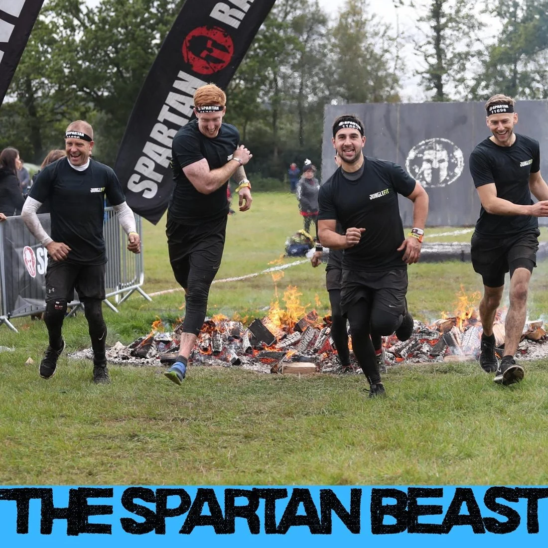 JungleFit members running towards the fire jump at the Spartan Beast obstacle race