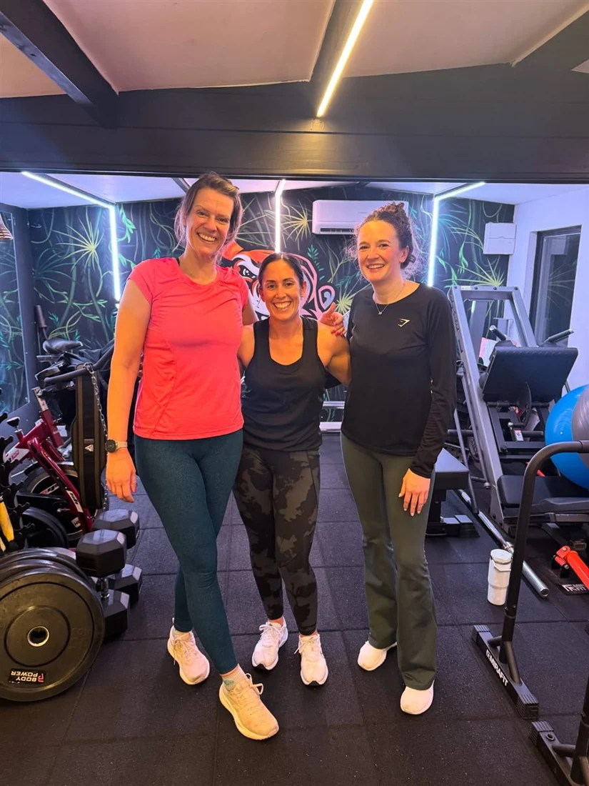 Three JungleFit members smiling after a session in the studio